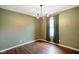 Dining room featuring elegant chandelier, wood floors, and neutral walls at 6670 Shooting Star Dr, Whitestown, IN 46075