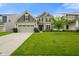 Inviting two-story home featuring a well-manicured lawn, attached two-car garage, and charming curb appeal at 6670 Shooting Star Dr, Whitestown, IN 46075