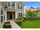 This two-story home features a landscaped front yard, a brick entryway, and an inviting porch at 6670 Shooting Star Dr, Whitestown, IN 46075