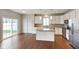 Well-equipped kitchen with stainless steel appliances, granite countertops, and hardwood floors in a bright, open space at 6670 Shooting Star Dr, Whitestown, IN 46075