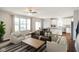 Inviting living room with hardwood floors, large windows, and neutral-toned furniture for a relaxing atmosphere at 6670 Shooting Star Dr, Whitestown, IN 46075