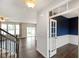 Open-concept living area featuring hardwood floors, abundant natural light, and staircase access at 6670 Shooting Star Dr, Whitestown, IN 46075