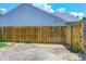 Fenced backyard with a mix of concrete patio, stone, and grass, perfect for outdoor entertaining and relaxation at 6740 Sundown S Dr, Indianapolis, IN 46254