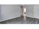 A bedroom with gray walls and wood-look floors leads to a bathroom and a closet at 6740 Sundown S Dr, Indianapolis, IN 46254