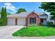 Charming brick home featuring a two-car garage and well-maintained front yard at 6740 Sundown S Dr, Indianapolis, IN 46254