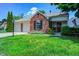 Charming brick home with manicured lawn, mature landscaping, and attached two-car garage at 6740 Sundown S Dr, Indianapolis, IN 46254