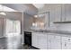 Kitchen featuring white cabinets, granite countertops, and view into the living area at 6740 Sundown S Dr, Indianapolis, IN 46254