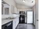 Efficient kitchen featuring white cabinets, granite countertops, and black appliances at 6740 Sundown S Dr, Indianapolis, IN 46254
