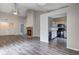 Open-concept living area with vaulted ceiling, fireplace, and adjacent kitchen at 6740 Sundown S Dr, Indianapolis, IN 46254