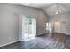 Bright living room showcasing sliding glass doors and wood-look flooring at 6740 Sundown S Dr, Indianapolis, IN 46254