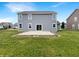 View of the backyard featuring a concrete patio and green lawn space perfect for outdoor activities at 6933 Sonora Blvd, Clermont, IN 46234