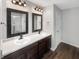 Bathroom featuring a double vanity with modern fixtures and a decorative mirror at 6933 Sonora Blvd, Clermont, IN 46234