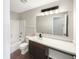 Bathroom featuring a modern vanity, dark wood floors, and shower-tub combo at 6933 Sonora Blvd, Clermont, IN 46234