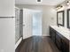 Modern bathroom featuring double sinks, a glass-enclosed shower, and wood-look flooring at 6933 Sonora Blvd, Clermont, IN 46234