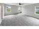 Large bedroom with multiple windows, carpet flooring, and a ceiling fan at 6933 Sonora Blvd, Clermont, IN 46234