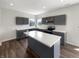 Stylish kitchen with dark cabinets, a bright white island, and modern stainless steel appliances at 6933 Sonora Blvd, Clermont, IN 46234