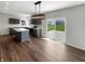 Modern kitchen with an island, stainless steel appliances, and access to the patio at 6933 Sonora Blvd, Clermont, IN 46234