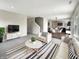 Bright living room featuring modern furniture, a striped rug, and an open floor plan at 6933 Sonora Blvd, Clermont, IN 46234