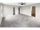 Large carpeted main bedroom with a ceiling fan, ample space, and multiple closets at 6933 Sonora Blvd, Clermont, IN 46234