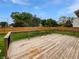 Large wooden back deck with railing overlooking a well-manicured lawn and fenced in yard at 770 Tulip Ln, Greenwood, IN 46143