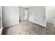 Spacious bedroom with neutral carpet, a walk-in closet, and two doors to other areas of the home at 770 Tulip Ln, Greenwood, IN 46143