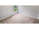 Empty bedroom with plush carpet, neutral wall paint, and a window at 770 Tulip Ln, Greenwood, IN 46143
