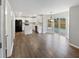 Open kitchen and dining area with white cabinets, stainless steel appliances, and a view to the deck at 770 Tulip Ln, Greenwood, IN 46143
