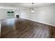 Spacious living room featuring hardwood floors, a fireplace, and a modern light fixture at 770 Tulip Ln, Greenwood, IN 46143