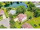 Aerial view of home with a spacious backyard, a play set, and a picturesque pond at 7755 Dayflower Ct, Noblesville, IN 46062