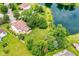 Aerial view of the home overlooking a large backyard, trees, and a tranquil pond at 7755 Dayflower Ct, Noblesville, IN 46062