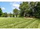Serene backyard with mature trees and a view of the water, offering a peaceful retreat at 7755 Dayflower Ct, Noblesville, IN 46062