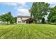 Expansive backyard featuring a covered patio and a well-manicured lawn, great for entertaining at 7755 Dayflower Ct, Noblesville, IN 46062