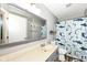 A bathroom featuring shark themed shower curtain, gray walls, and gray cabinets at 7755 Dayflower Ct, Noblesville, IN 46062