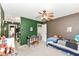 A bedroom featuring green and brown walls, gray carpet, and a ceiling fan at 7755 Dayflower Ct, Noblesville, IN 46062
