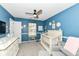 This Bedroom features blue walls, gray carpet, ceiling fan, and white furniture at 7755 Dayflower Ct, Noblesville, IN 46062