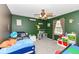 A bedroom featuring green walls, gray carpet, and a ceiling fan at 7755 Dayflower Ct, Noblesville, IN 46062