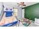A bedroom features an indoor basketball hoop, light gray walls, and green accent wall at 7755 Dayflower Ct, Noblesville, IN 46062