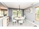 Cozy dining area features a round table, white chairs, and a decorative light fixture at 7755 Dayflower Ct, Noblesville, IN 46062