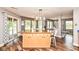 Bright kitchen with a large island, wood floors, and sliding glass doors leading to the outside at 7755 Dayflower Ct, Noblesville, IN 46062
