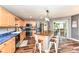 This is a spacious kitchen with stainless steel appliances, wood cabinets, and a large island with seating at 7755 Dayflower Ct, Noblesville, IN 46062