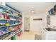 Bright laundry room with white appliances, built-in shelves, and access to the backyard at 7755 Dayflower Ct, Noblesville, IN 46062