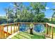 Open back deck area with two lounge chairs and an accent table overlooking private backyard at 8140 Bold Forbes Ct, Indianapolis, IN 46217