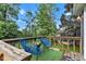 Relaxing back deck with blue chairs, perfect for outdoor entertaining and enjoying the surrounding natural landscape at 8140 Bold Forbes Ct, Indianapolis, IN 46217