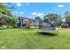 Spacious backyard with lush lawn, mature trees, and a trampoline at 8140 Bold Forbes Ct, Indianapolis, IN 46217