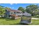 A well-manicured backyard with a trampoline and a deck adjacent to the house at 8140 Bold Forbes Ct, Indianapolis, IN 46217