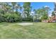 Spacious backyard with basketball court and mature trees at 8140 Bold Forbes Ct, Indianapolis, IN 46217
