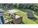 Backyard featuring a trampoline, basketball court, and a wooden deck with a hot tub at 8140 Bold Forbes Ct, Indianapolis, IN 46217