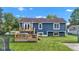 A shot of the backyard with a wooden deck, hot tub, and lush lawn at 8140 Bold Forbes Ct, Indianapolis, IN 46217