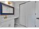 This bathroom features a white vanity with a marble countertop and a mirror with an intricate blue design at 8140 Bold Forbes Ct, Indianapolis, IN 46217