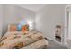 Charming bedroom features natural lighting, floral comforter, neutral walls, and stylish furniture at 8140 Bold Forbes Ct, Indianapolis, IN 46217
